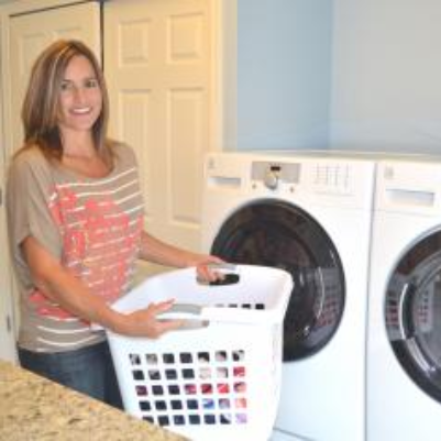 Woman holding laundry basket.