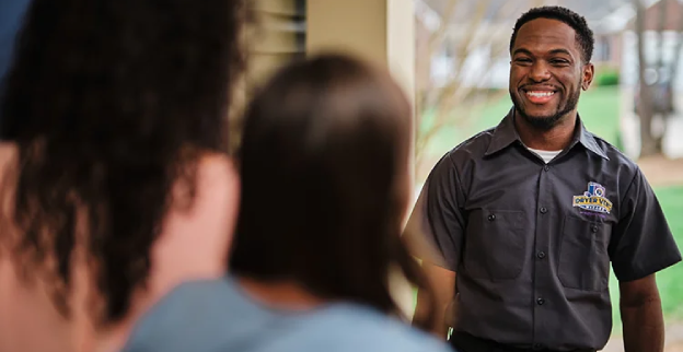 Dryer Vent Wizard technician greeting a family at a residential dryer vent cleaning appointment.