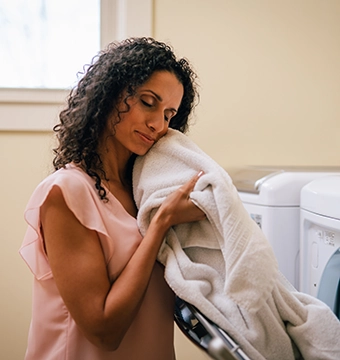 woman holding fresh laundry.