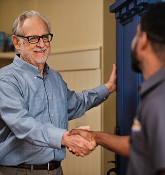 Dryer Vent Wizard technician greeting a customer at the door.