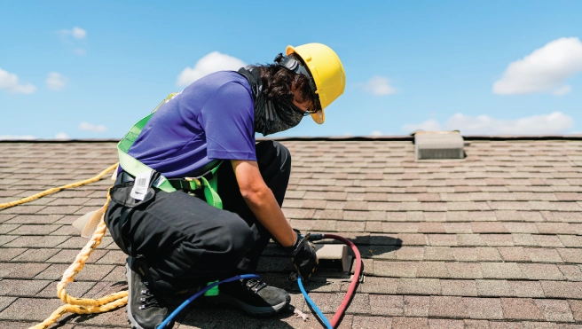 Dryer vent rerouting taking place on roof by a professional dryer vent cleaner.