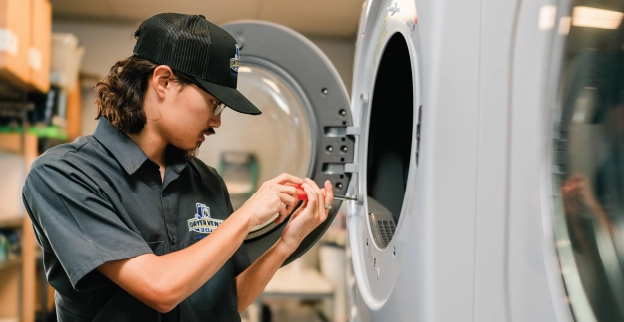 Dryer Vent Wizard professional adjusting commercial dryer.