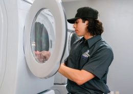 Dryer vent cleaning professional from Dryer Vent Wizard inspecting commercial dryers.