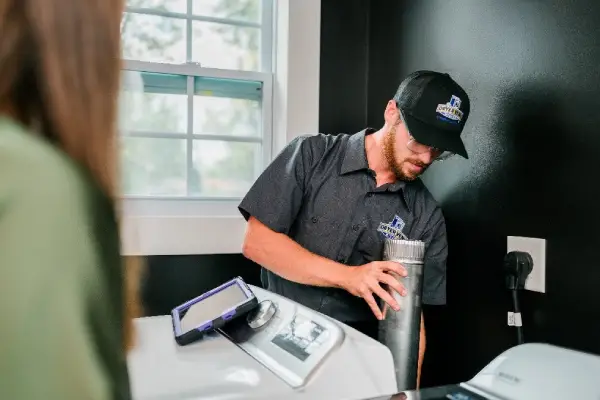 Dryer Vent Wizard professional explaining dryer vent installation service to a customer