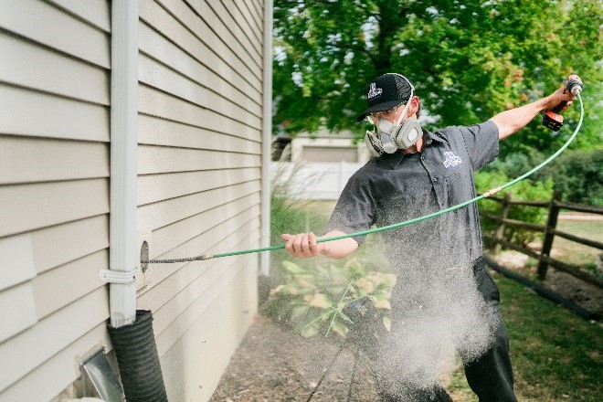 Dryer Vent Wizard professional performing dryer vent cleaning service.