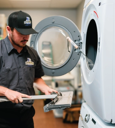 Dryer Vent Wizard professional taking measurements of a commercial dryer.