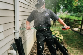 Dryer Vent Wizard professional outside of home cleaning dryer vent ducts.