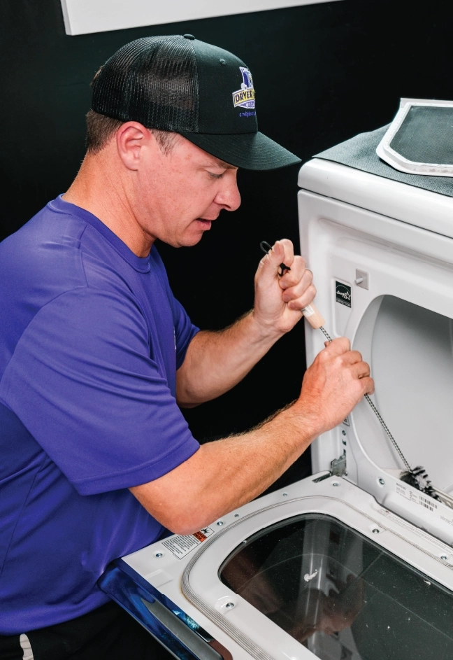 Male dryer vent cleaning professional fixes dryer vent lint trap.