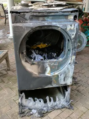 A picture of a burnt-out dryer after catching on fire.