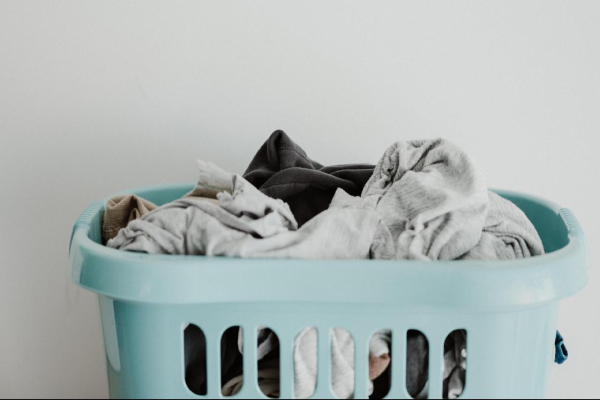 A laundry basket full of dirty clothes.