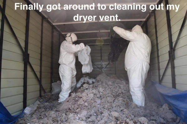 Two men in hazmat suits emptying bags of drayer lint into a shipping container with the text "Finally got around to cleaning out my dryer".