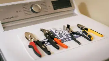 A set of tools layed out on a dryer.