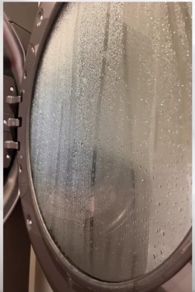 Moisture built up in the door of a front-loading dryer.