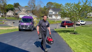 Technician walking in driveway.