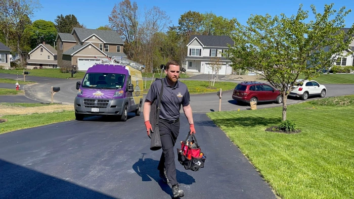 Technician walking in driveway.