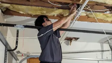 A Dryver Vent Wizard technician working in a customer's garage.