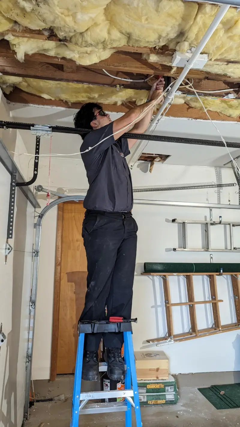 A Dryver Vent Wizard technician working in a customer's garage.