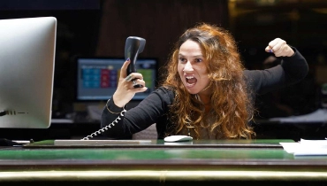 A picture of an angry customer service rep screaming into the phone.