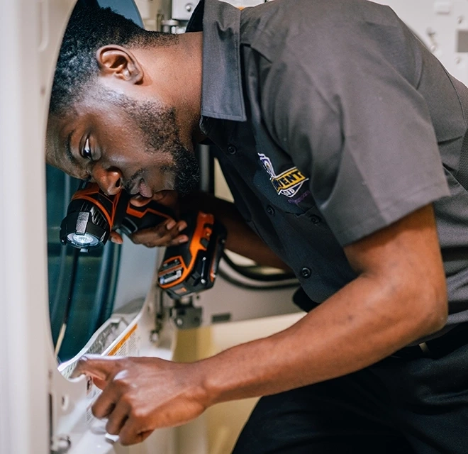 Professional examining dryer vent trap.